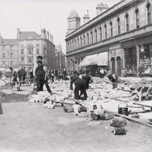 A black and white photograph of men laying the tramrails in 1903