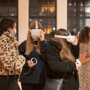 Two people wearing virtual reality headsets