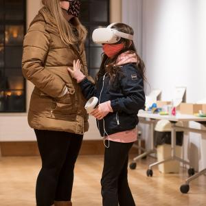 A woman and child wearing virtual reality headsets