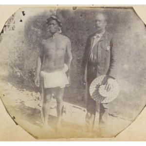 A chief from the Marquesas Islands in loin cloth, and a Captain in suit holding straw hat