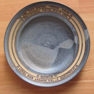 Grey ceramic plate with yellow trim and inscribed The Pitt Rivers Award 2002, Edinburgh Arc. Field Soc. winner