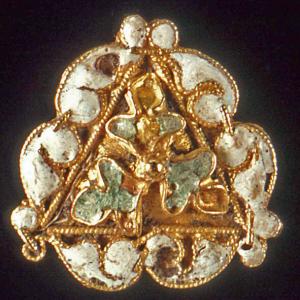 Elaborate gold button complete with white and green stones